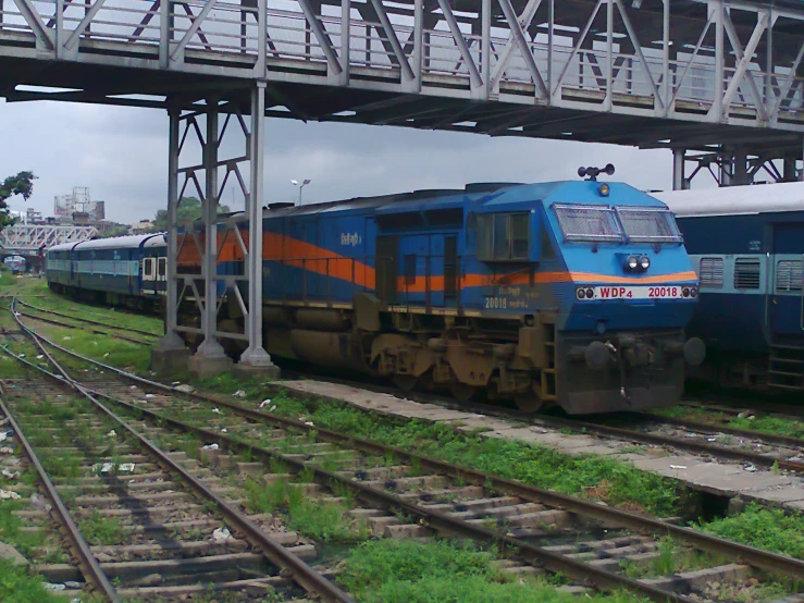 two trains passing each other under a bridge