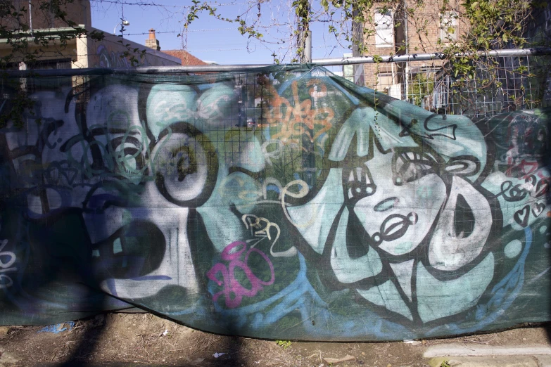 some graffiti is drawn on the side of a fence