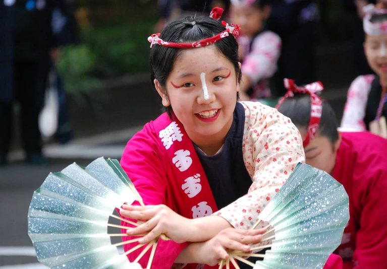 an asian woman is holding a parasol and smiling