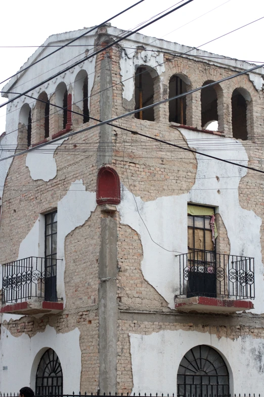 an old building with crumbling exterior and iron balconyes