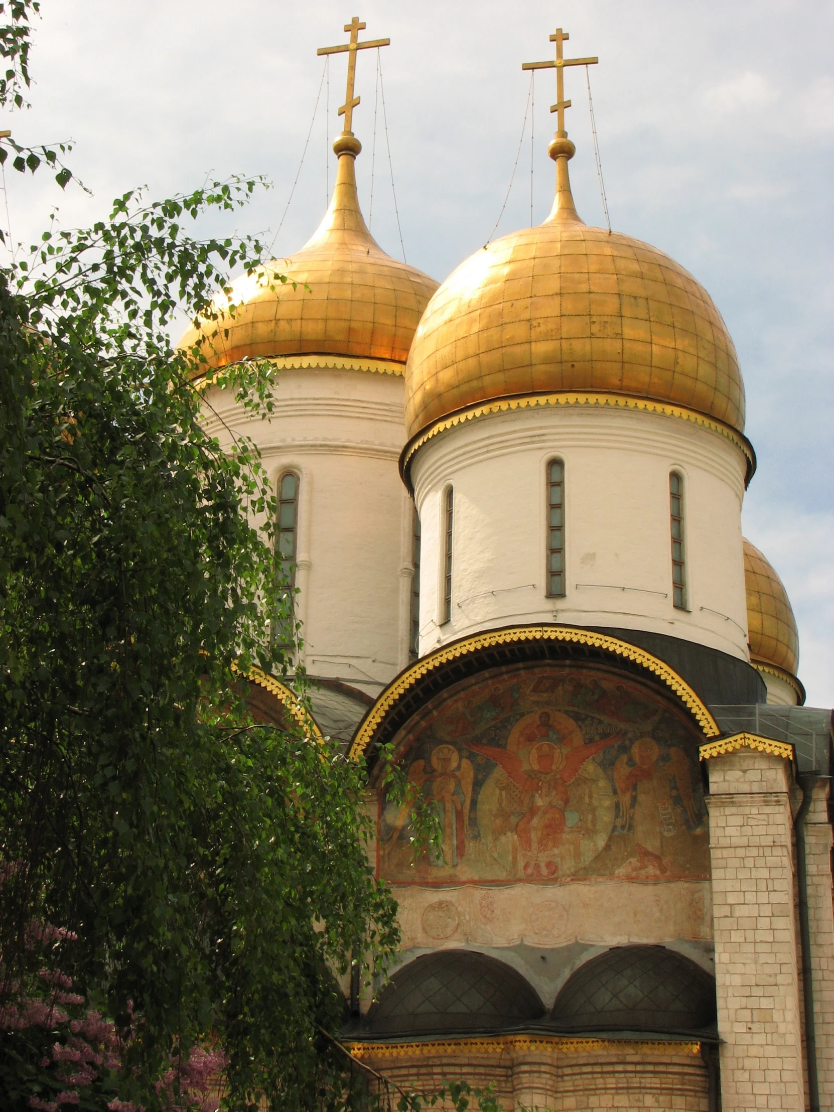 a church with a golden dome and crosses on the top of it