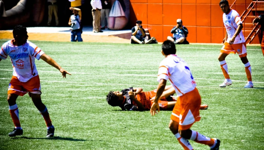 a group of people playing soccer on a field