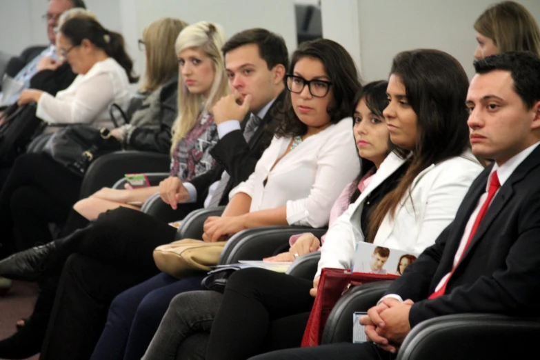 a large group of people sitting next to each other