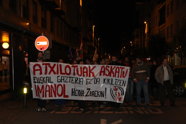 a crowd of people protesting outside at night