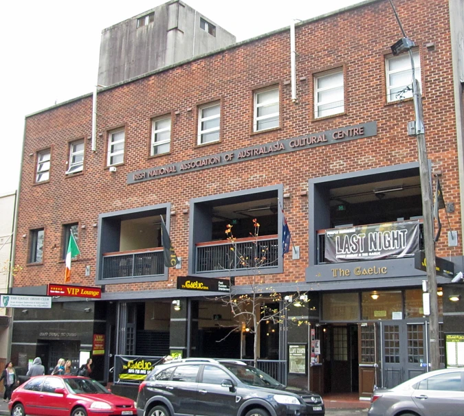 some cars and a building with three story