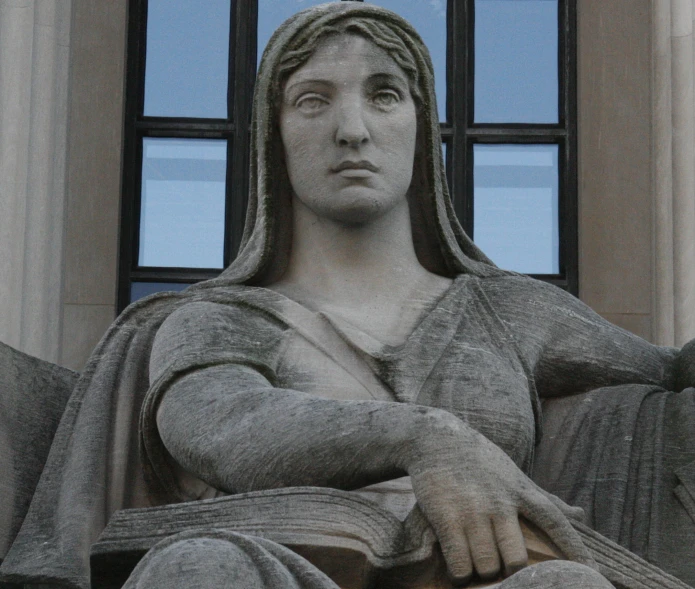 this statue is made with stone and has a black head