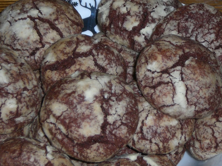 many brown and white cookies on top of each other
