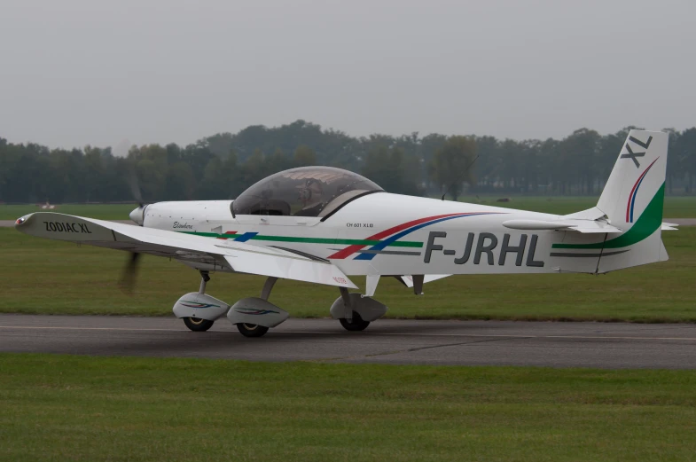 a white plane is sitting on the runway