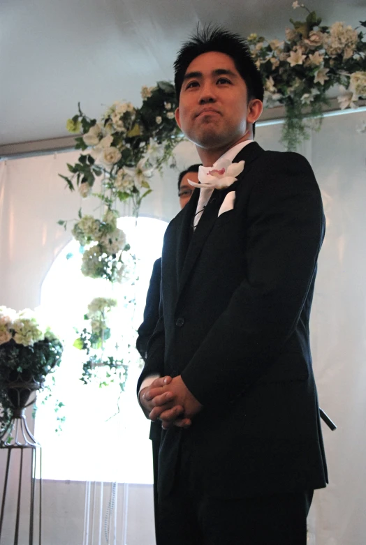 a man wearing a suit and bow tie is posing for the camera