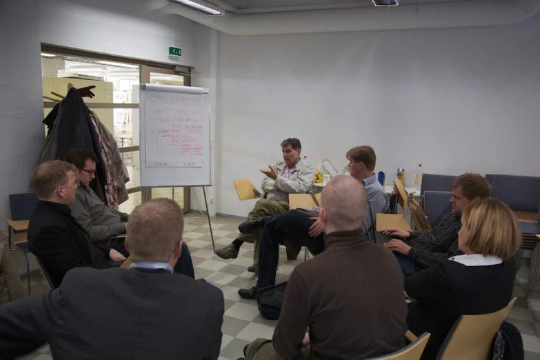 a bunch of people sitting down in chairs