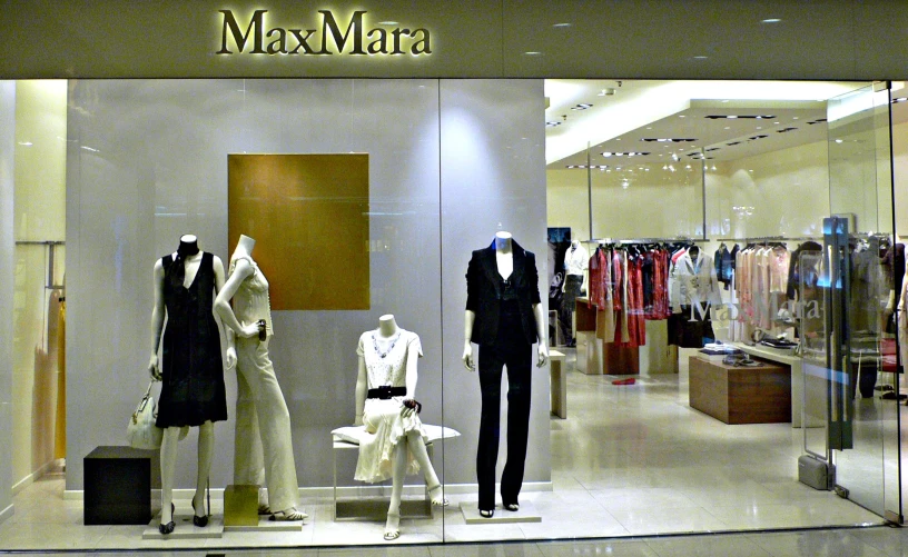 a group of mannequins are standing in front of a display