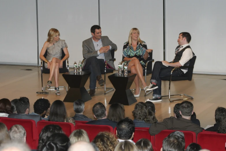 several people sitting in chairs with a speaker