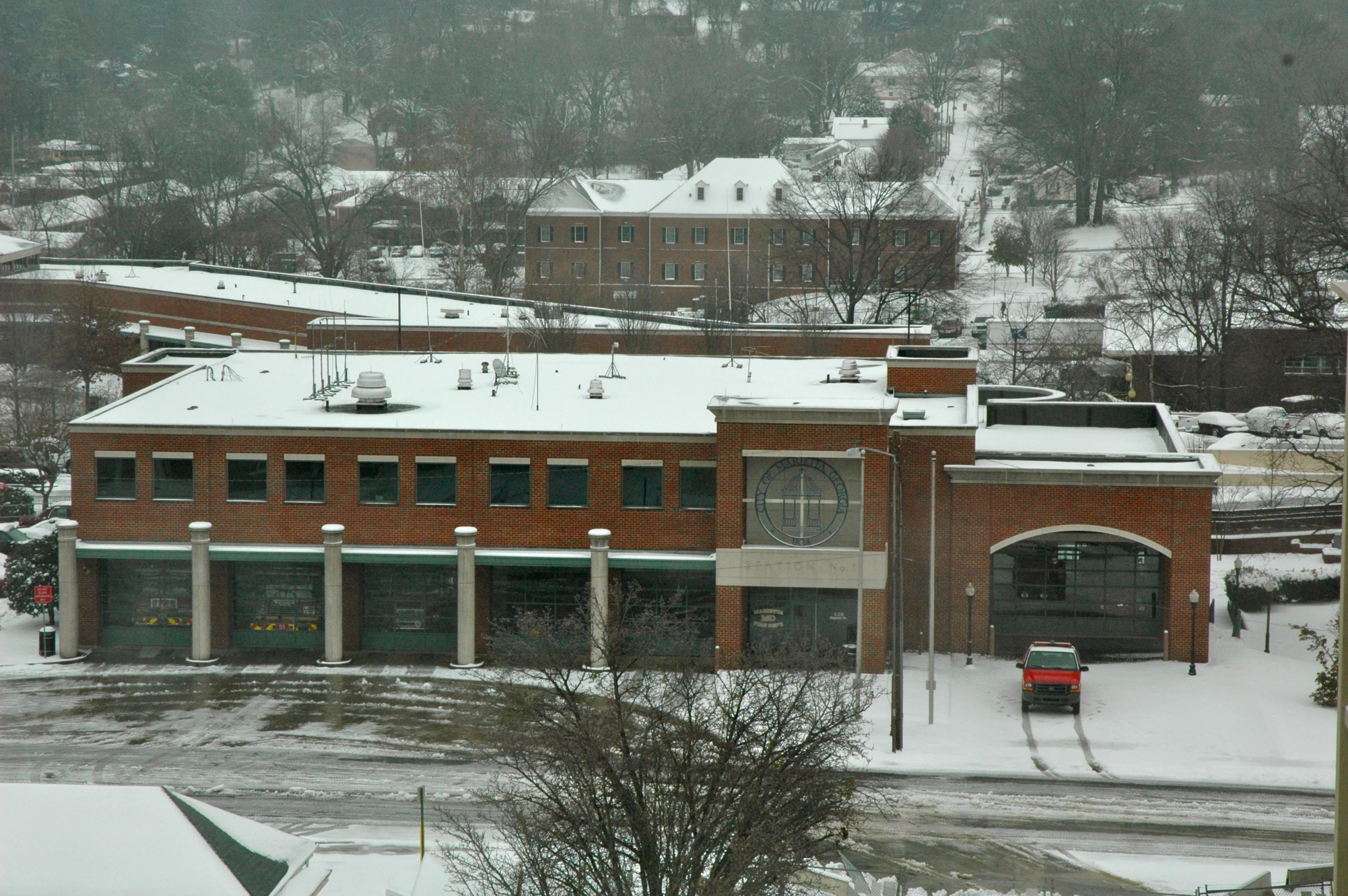 there are buildings on the snow covered hillside