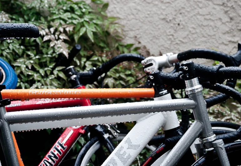 multiple bikes lined up against a stone wall