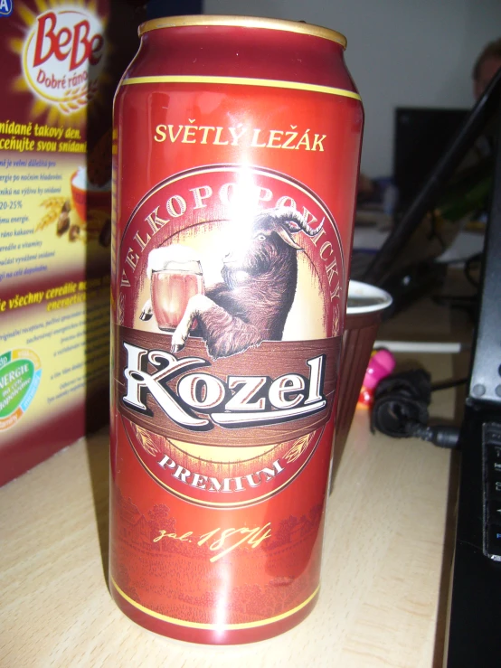 this is an orange can of koze on a table