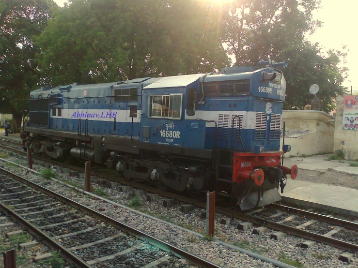 a train is on the train tracks near many trees