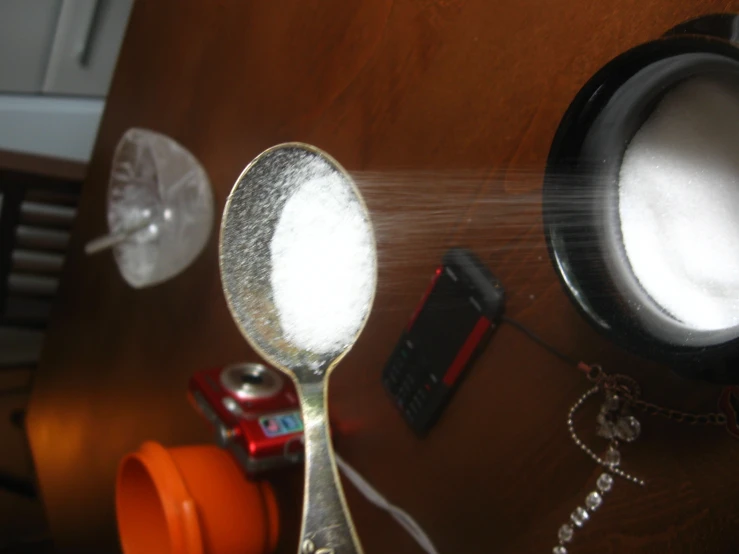 a kitchen table with bowls of cereal and an ipod