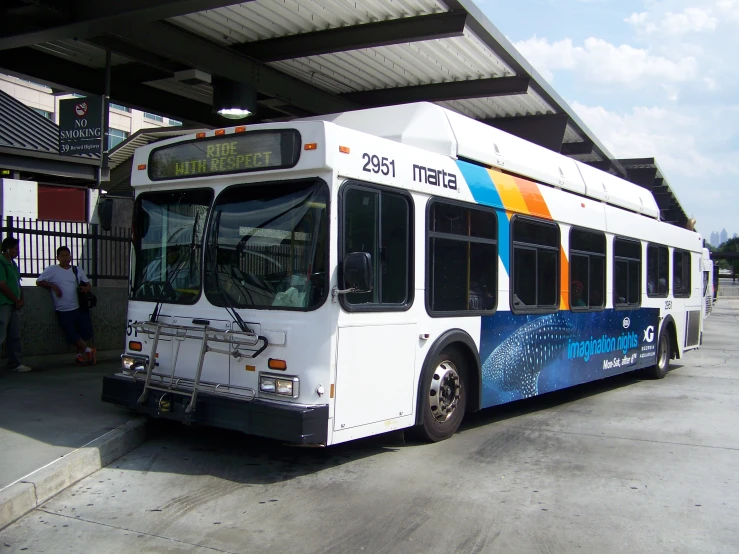 a colorful bus is parked at the station