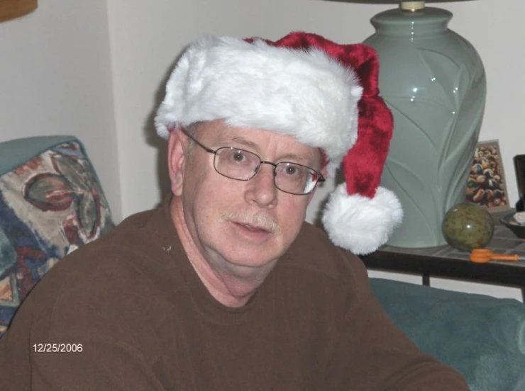 a man wearing glasses and a santa hat