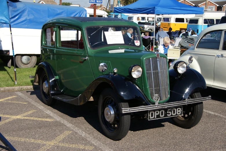 an old car parked at the antique car show