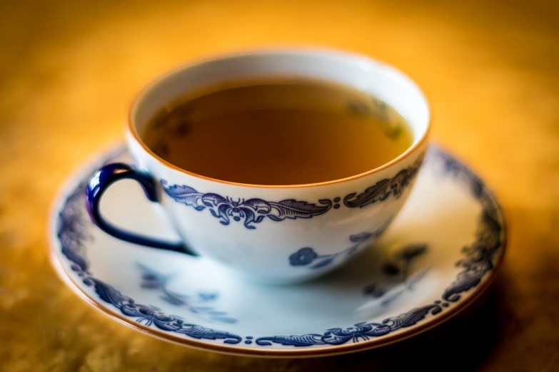 a coffee cup on a saucer that has been placed