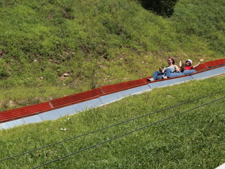 two women who are laying on the side of a road