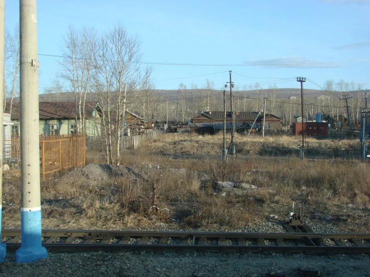 looking out on the tracks in the foreground is an old building