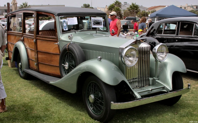 an antique car at an auto show, in the foreground