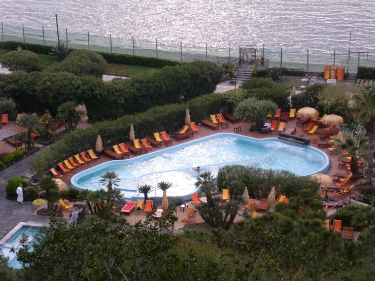 the outdoor pool is located near a large body of water