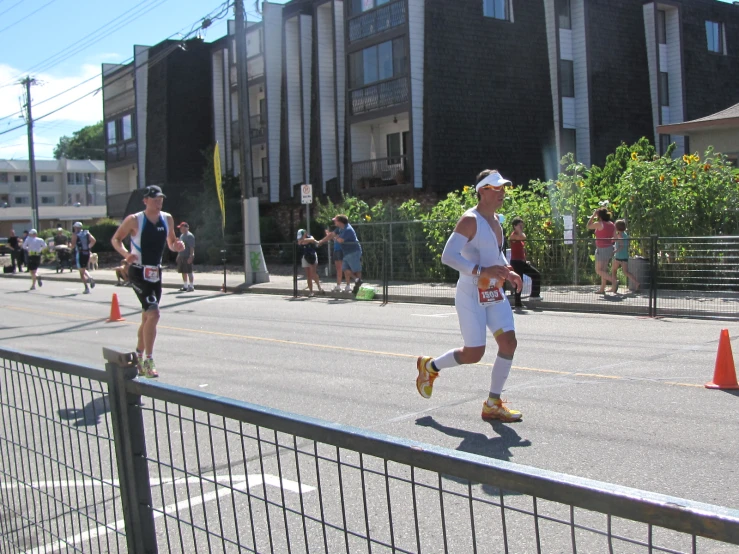 a group of men running down a street next to buildings