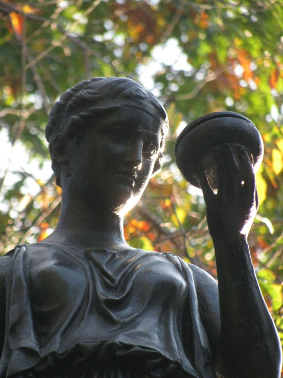 a statue holding a lamp in her hand
