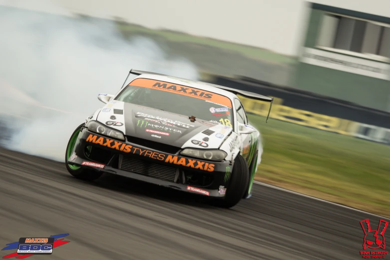 the man drives his car down the track as a cloud of smoke comes up from underneath