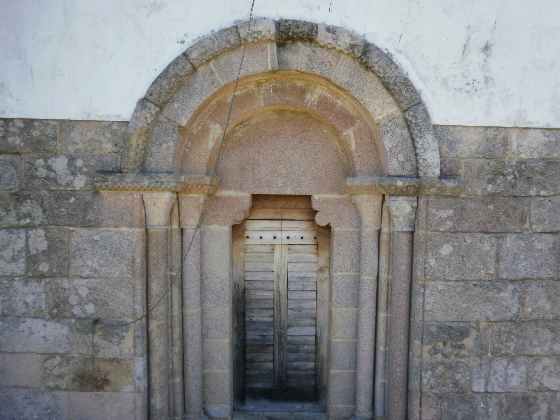 several door are in between two stone arches