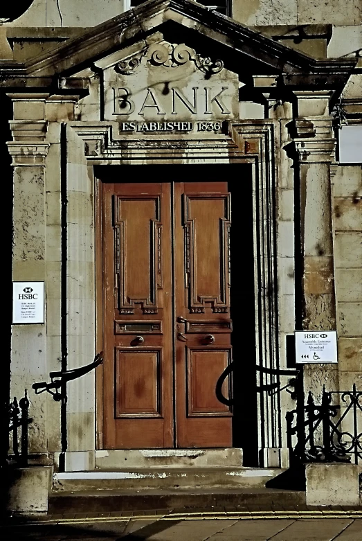 two brown doors are on the outside of a building