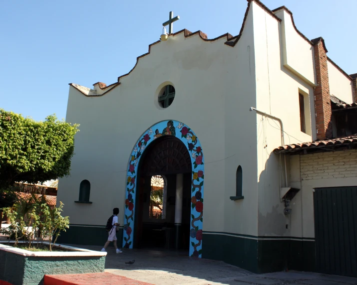 a man walks out from the door of a large church