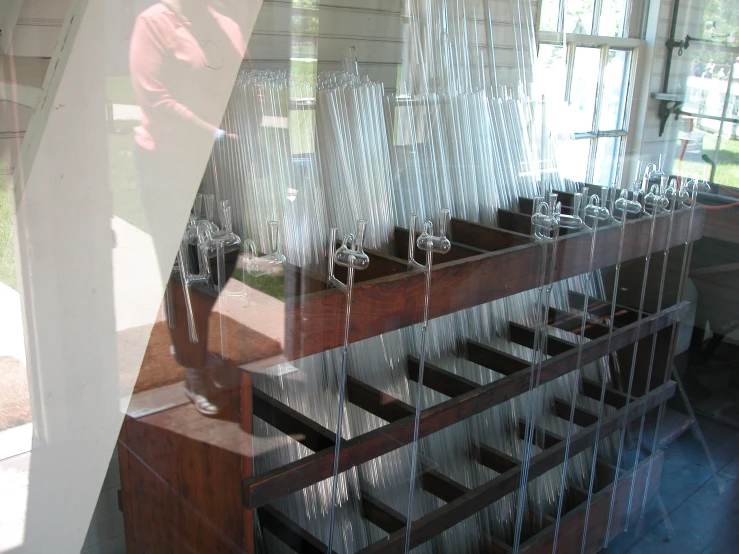 large wine glasses on display behind glass panels