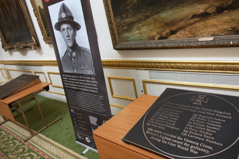 a sign is sitting in front of two tables with plaques on it