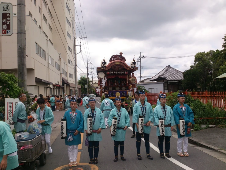 group of japanese men with marching equipment on street