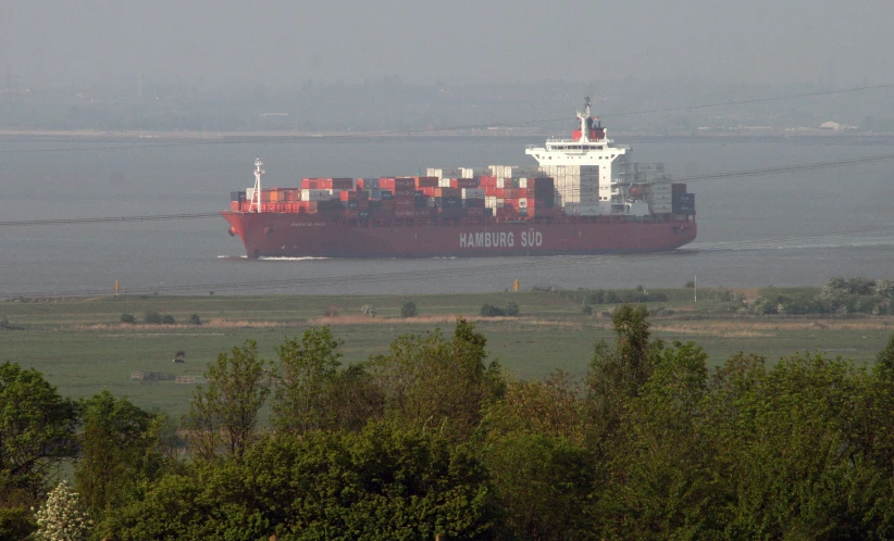 the cargo ship is moving toward shore