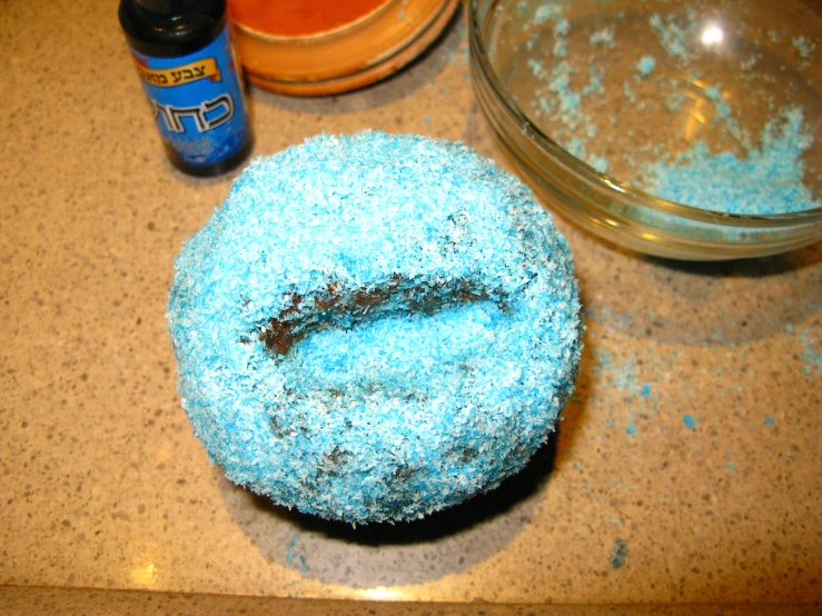 there is a blue donut with icing and sprinkles on it