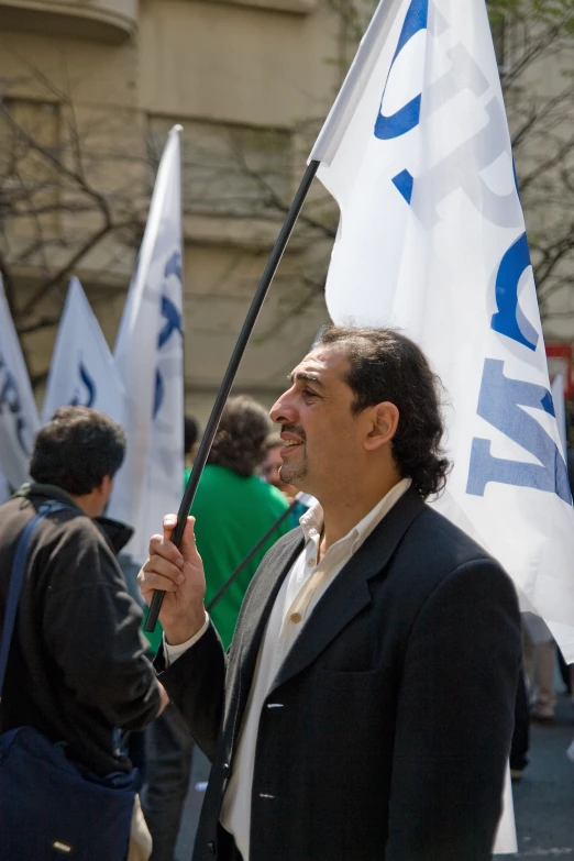 a man holding an israeli flag during a demonstration