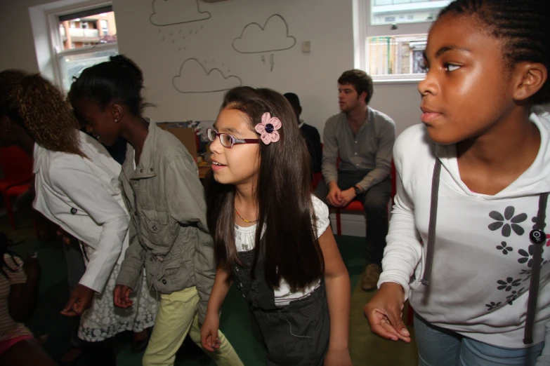 group of children are standing around each other