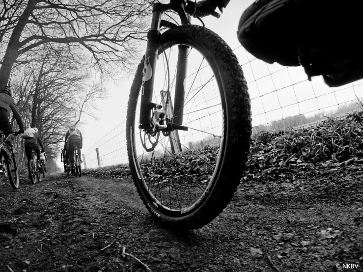 two people riding their bikes on a path