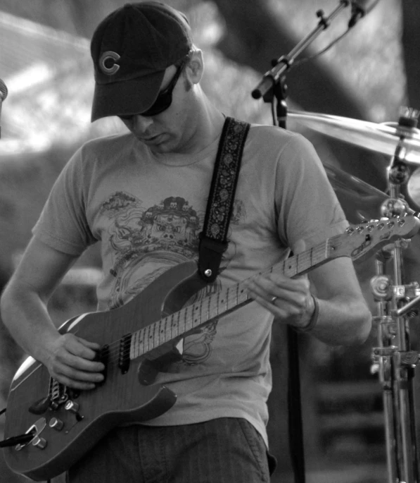 a man that is standing up with a guitar