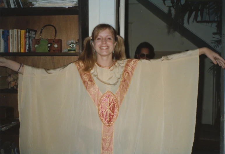 woman in large, colorful costume next to stair case