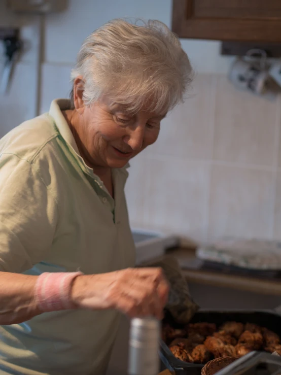 an older woman prepares to cook food in the kitchen