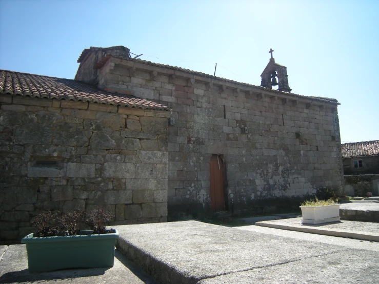 a building made of stone, with a steeple on top