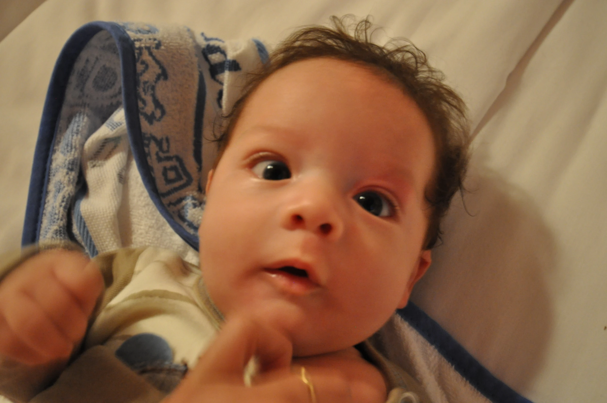 a baby laying down looking up at the camera