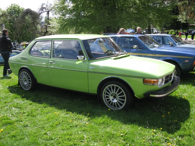 a bright green car sitting in the grass