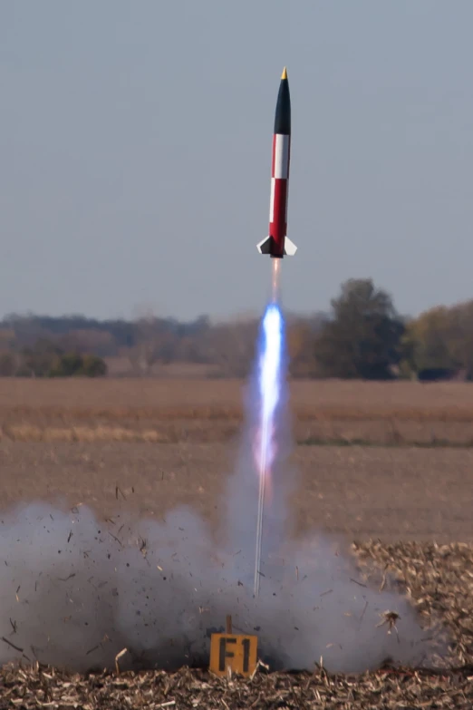 a rocket launching from the ground and releasing smoke and liquid